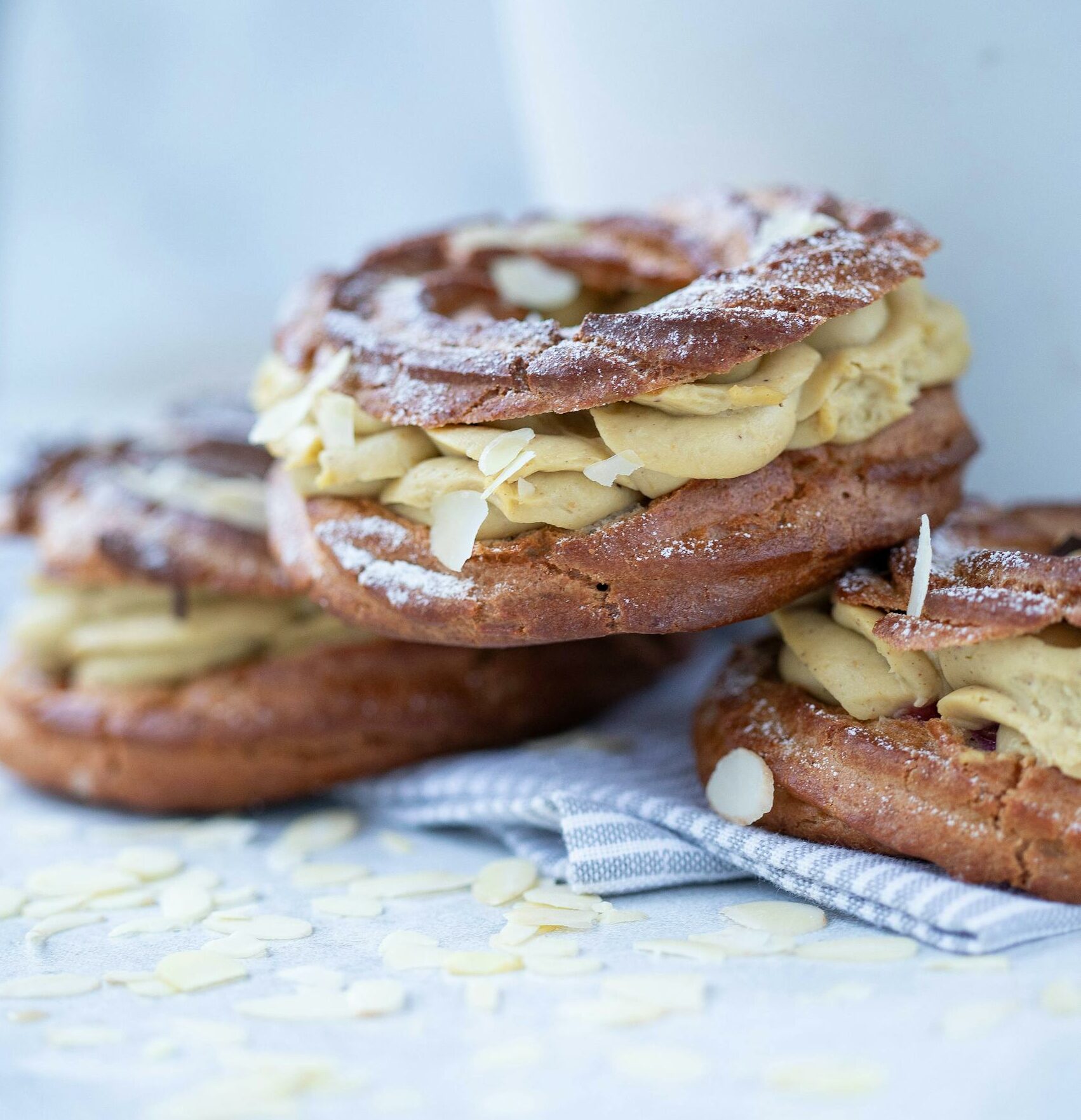 Delicious Paris-Brest pastry topped with almond slices and cream.